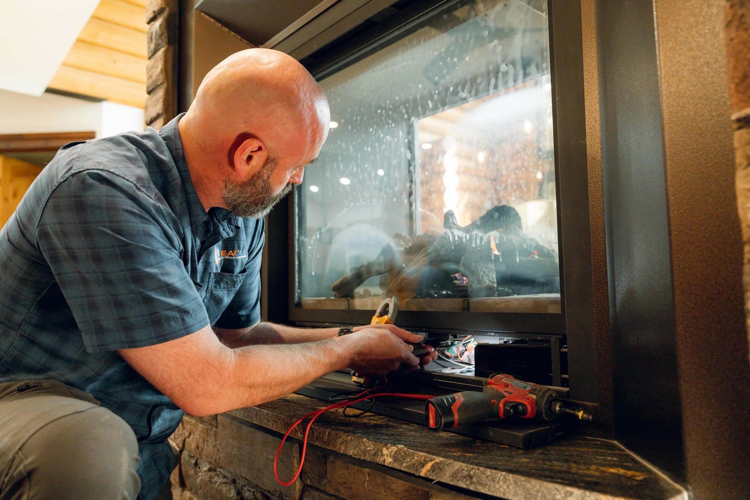 Eagle Heating and Air technician diagnosing a fireplace system