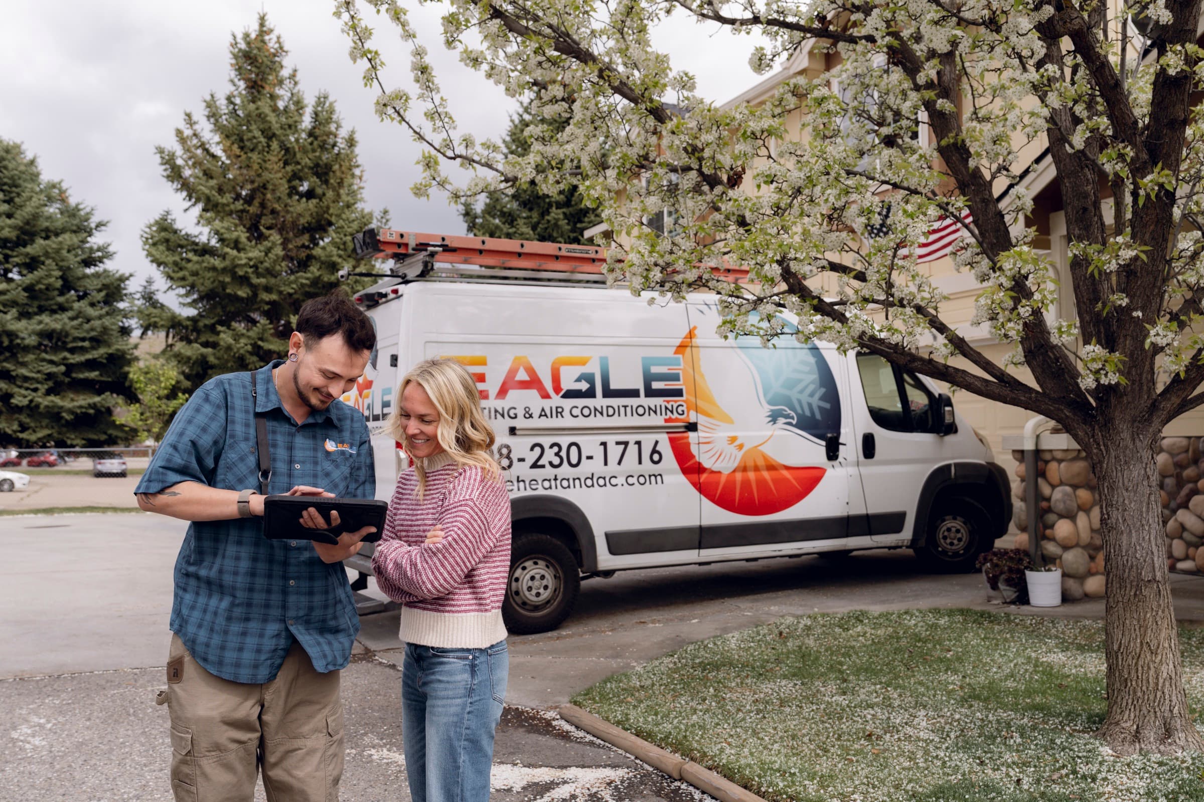 Eagle Heating and Air technician reviewing HVAC service details with a homeowner