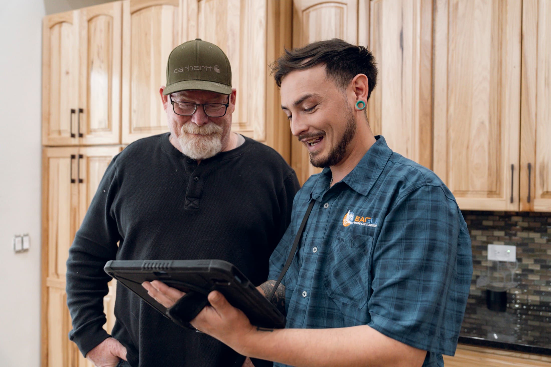 Eagle Heating and Air technician reviewing maintenance details with a homeowner