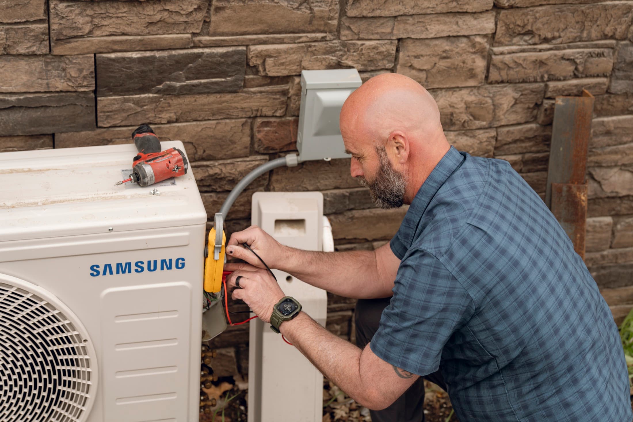 Eagle Heating and Air technician servicing an outdoor residential air conditioner
