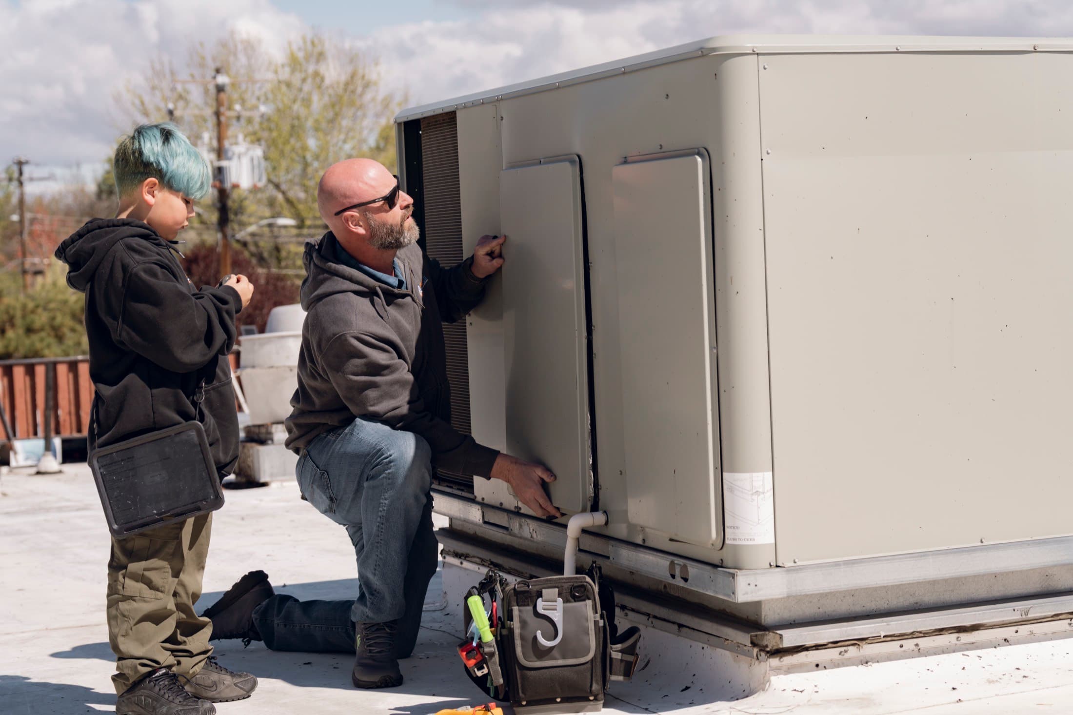 Eagle Heating and Air technician servicing a commercial rooftop HVAC unit